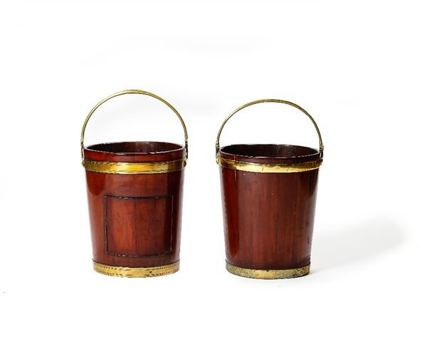 A near pair of mid 18th century brass cooper bound peat buckets, with swing overhandles, each 38cm wide x 46cm high, excluding handles (2).