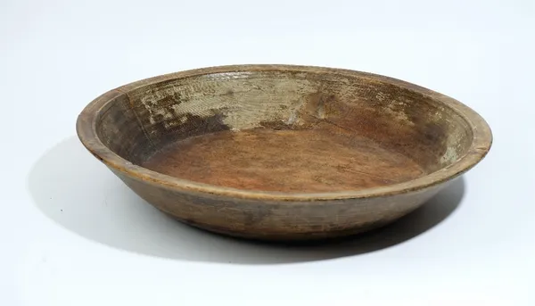 A large shallow turned hardwood fruit bowl, 59cm diameter x 11cm high.