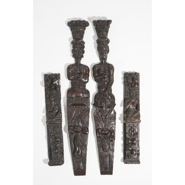 Two pairs of carved oak figural terms, probably Elizabeth I/James I, one pair carved with a semi nude bearded man below bunches of fruit and above a p