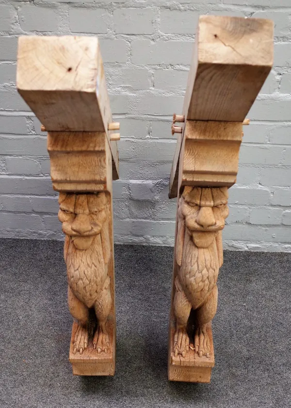 A pair of oak corner brackets relief carved with grotesque figures, 90cm wide x 94cm high, (2).