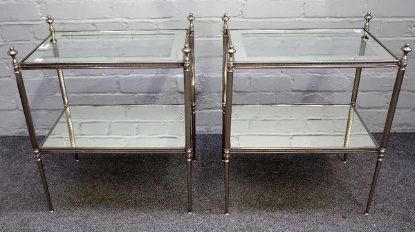 A pair of 20th century silvered metal and glass rectangular two tier occasional tables, on turned supports, 50cm wide x 59cm high. (2).