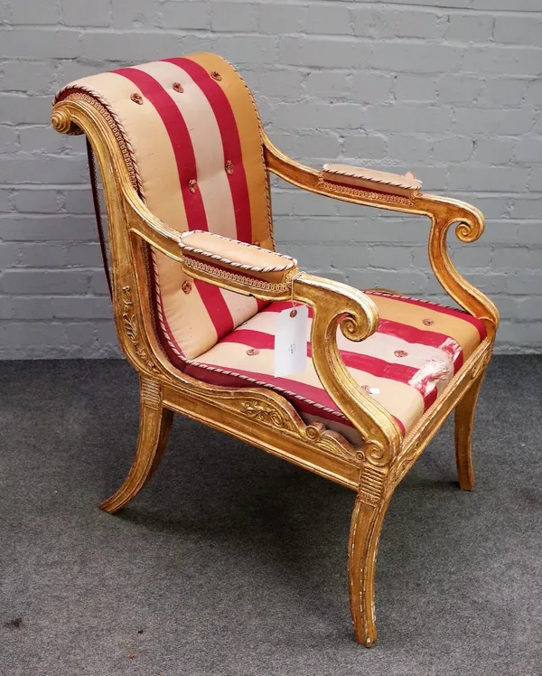 In the Manner of Henry Holland; A Regency gilt framed open armchair, with semi-padded arms and straight front seat, on sabre supports, 61cm wide x 91c