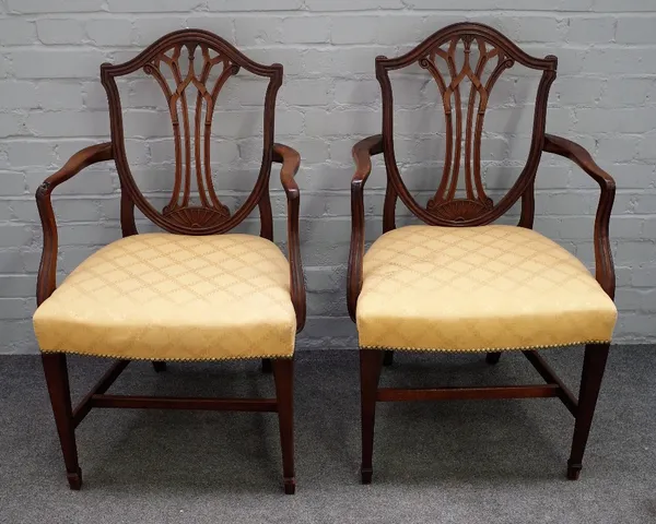 A pair of George III mahogany shield back open armchairs on tapering square supports, 60cm wide x 96cm high.