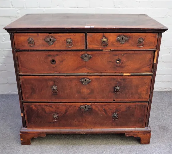 An early 18th century featherbanded walnut chest with two short and three long graduated drawers on bracket feet, 99cm wide x 89cm high.