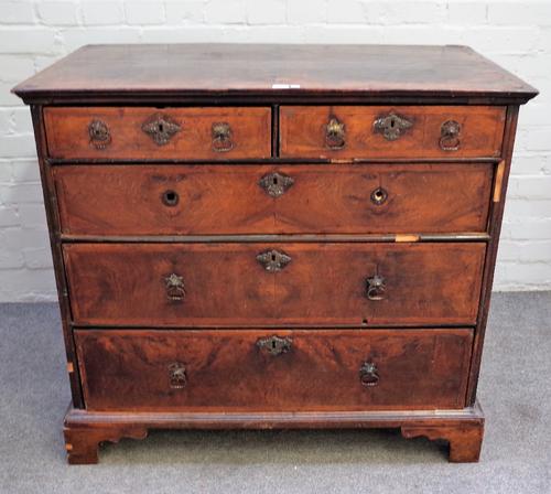 An early 18th century featherbanded walnut chest with two short and three long graduated drawers on bracket feet, 99cm wide x 89cm high.