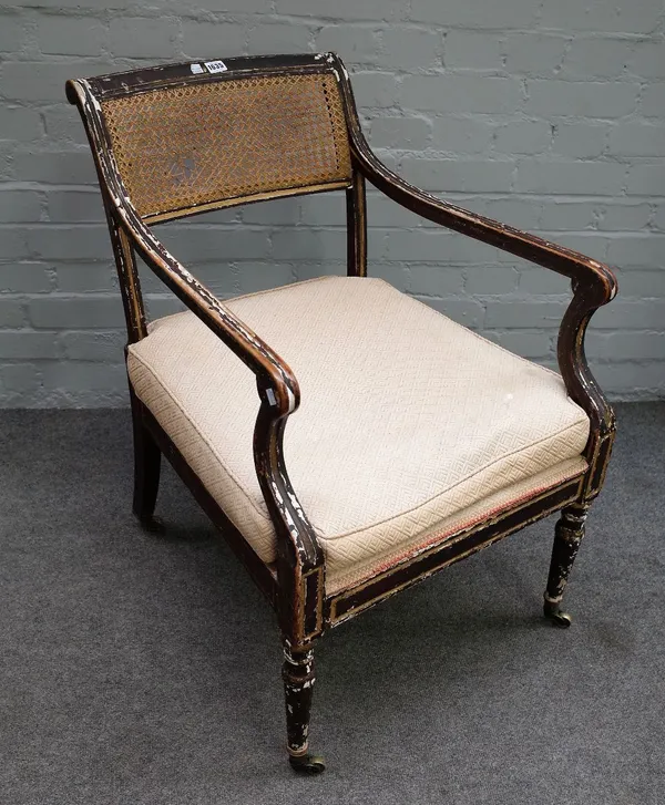 A Regency parcel gilt and ebonised open armchair on turned supports, 57cm wide x 80cm high.