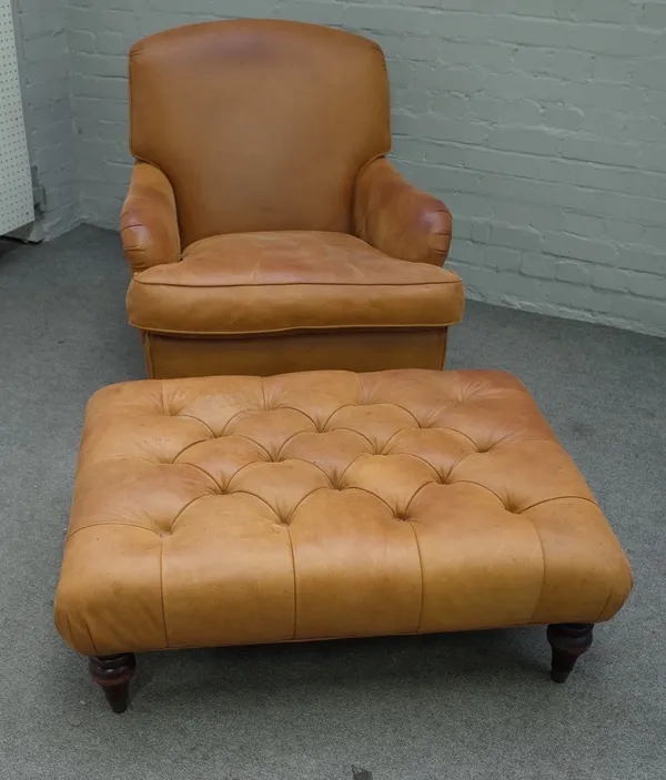 A 20th century brown leather upholstered easy armchair, on turned supports, 78cm wide x 88cm high, together with a matching footstool, 90cm wide x 35c