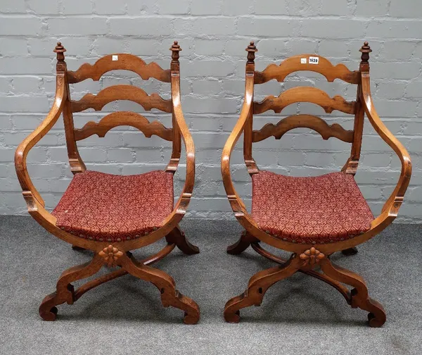 A pair of 19th century oak 'X' framed openarm side chairs, 55cm wide x 88cm high.