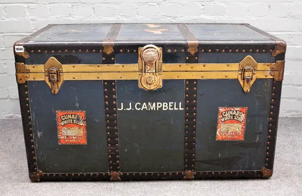 An early 20th century brass and metal bound travelling trunk with Cunard, White Star labelling, 100cm wide x 59cm high.