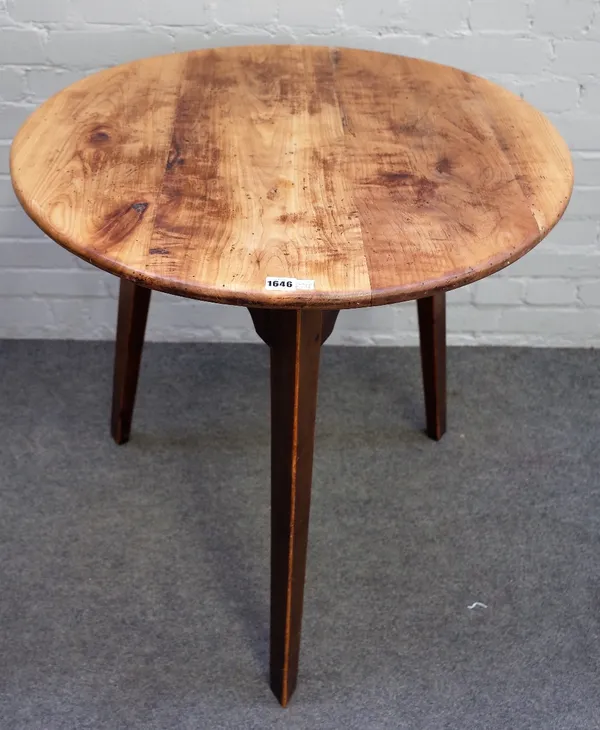 A George III fruitwood cricket table, the circular top on three canted square supports, 76cm diameter x 77cm high.