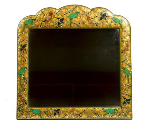 A Kashmiri green japanned and polychrome painted mirror, circa 1920, in late 17th century style, the shaped arched top frame elaborately painted with