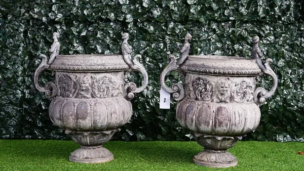 A pair of lead urns, in Louis XIV arabesque style, after a design by John Van Nost for William III's Hampton Court Palace, 70cm wide x 76cm high.