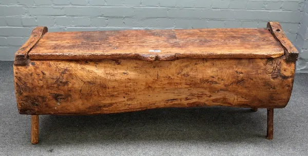 A pitch pine dug out chest on four staked supports, 128cm wide x 53cm high.