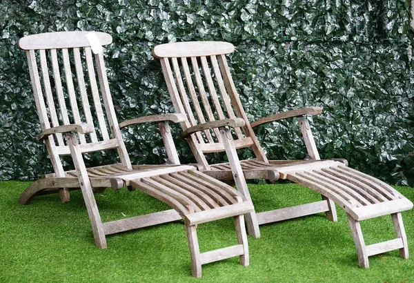 Barlow Tyrie; a pair of teak steamer reclining easy armchairs, 62cm wide x 170cm long (2).