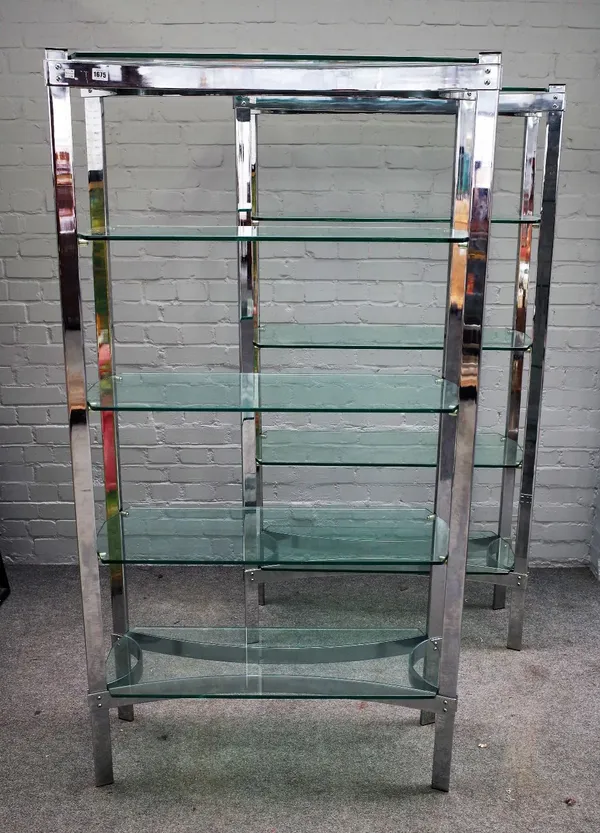 Probably Merrow Associates, a pair of 20th century chrome and glass five tier free standing shelves, of concave outline, 91cm wide x 176cm high.