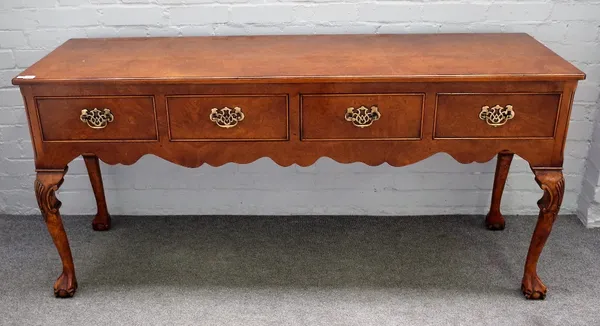 A George II style figured walnut serving table, with three frieze drawers on shell capped cabriole supports and ball and claw feet, 169cm wide x 80cm