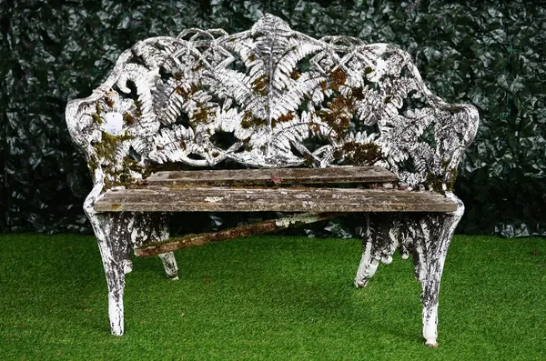 After Coalbrookdale; a fern and blackberry pattern green and white painted cast iron garden bench, 120cm wide x 87cm high.