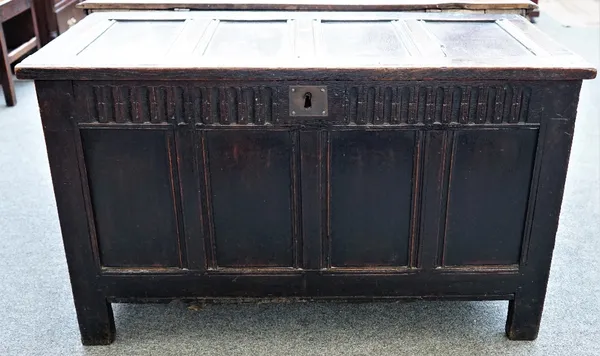 A late 17th century oak coffer, of panelled construction, with a gouged frieze, 114cm wide x 56cm deep x 67cm.