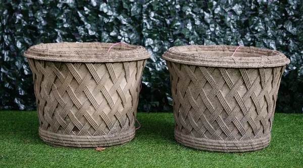 Haddonstone; A pair of reconstituted stone circular jardinieres with lattice work bodies, 61cm diameter x 45cm high (2)