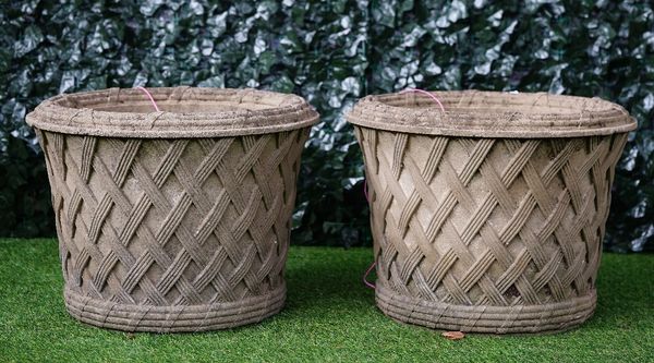 Haddonstone; A pair of reconstituted stone circular jardinieres with lattice work bodies, 61cm diameter x 45cm high (2)