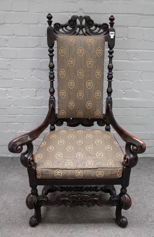 A William and Mary and later, walnut open armchair with outswept arms and carved stretcher, 73cm wide x 121cm high.