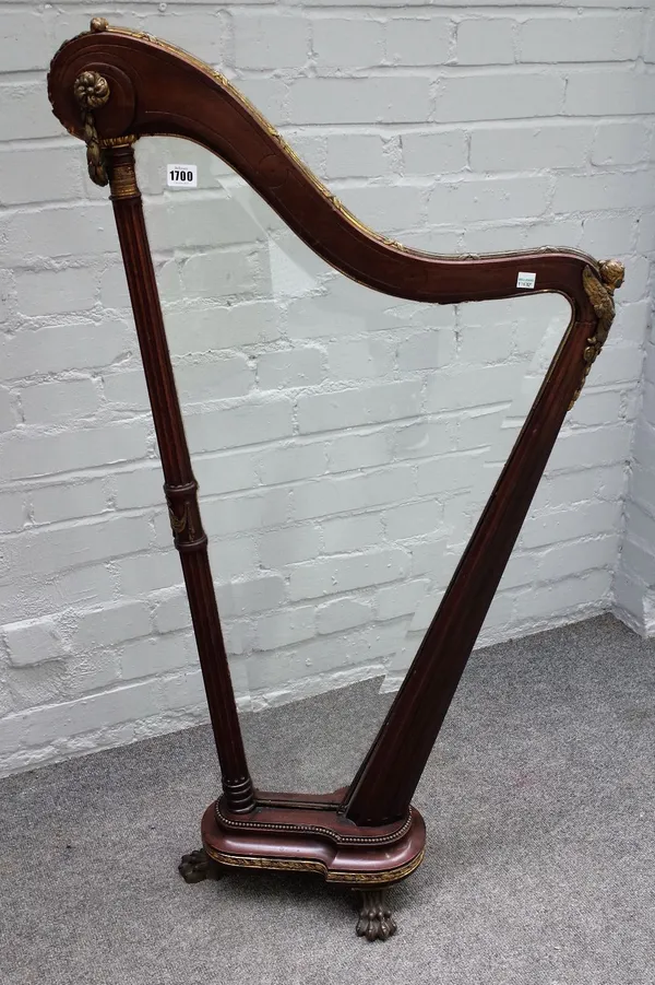 A 19th century gilt metal mounted mahogany firescreen, modelled as a harp on paw feet, 60cm wide x 114cm high.