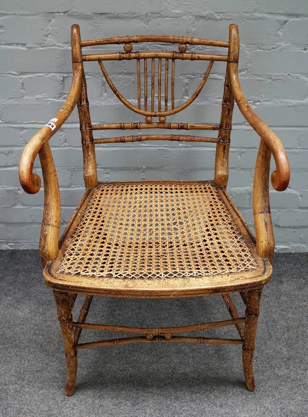 A Regency polychrome painted faux bamboo open armchair with cane seat on turned supports, 54cm wide x 82cm high.