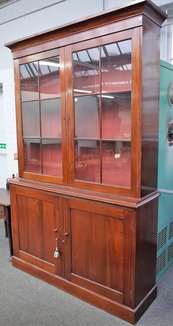 A George III mahogany bookcase cabinet, with pair of glazed doors over panelled cupboards, 154cm wide x 237cm high.