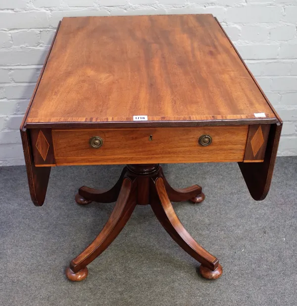 A Regency style mahogany rosewood crossbanded boxwood strung supper table, with hinged drop leaves, end drawer, on a quadripartite base, 84cm wide x 6