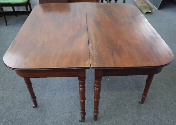 A late George III mahogany rounded rectangular extended dining table on turned supports with two extra leaves, 121cm wide x 120cm long x 207cm extende