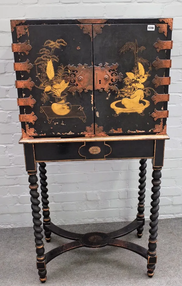 A Chinese Export black japanned and gilded cabinet, 18th century, fitted with an arrangement of eight drawers enclosed by a pair of doors with panels