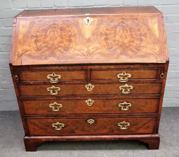 A mid-18th century feather banded figured walnut bureau, the fitted interior over four long graduated drawers, on bracket feet, 109cm wide x 105cm hig