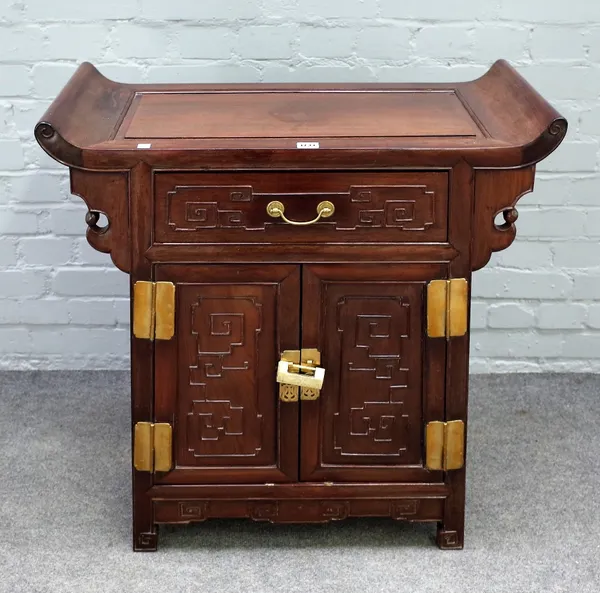 An early 20th century Chinese hardwood side cabinet, the upswept top over single drawer and cupboard, 77cm wide x 80cm high.