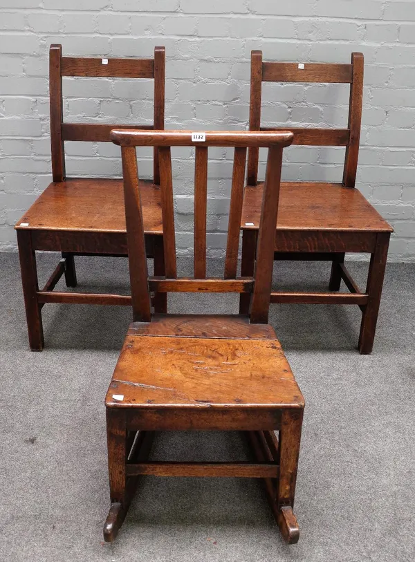 An oak rocking chair, 18th century, with triple splat back and solid seat, 43cm wide x 84cm high, and a pair of George III oak dining chairs with bar