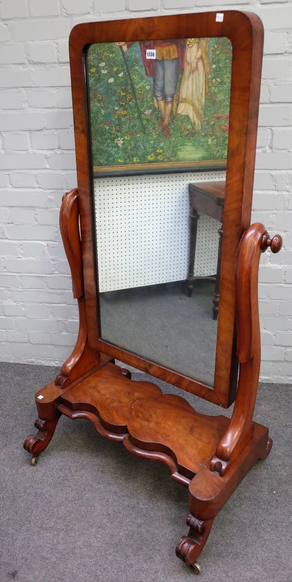 A Regency mahogany cheval mirror with scroll supports and serpentine base on four downswept supports, 82cm wide x 148cm high.