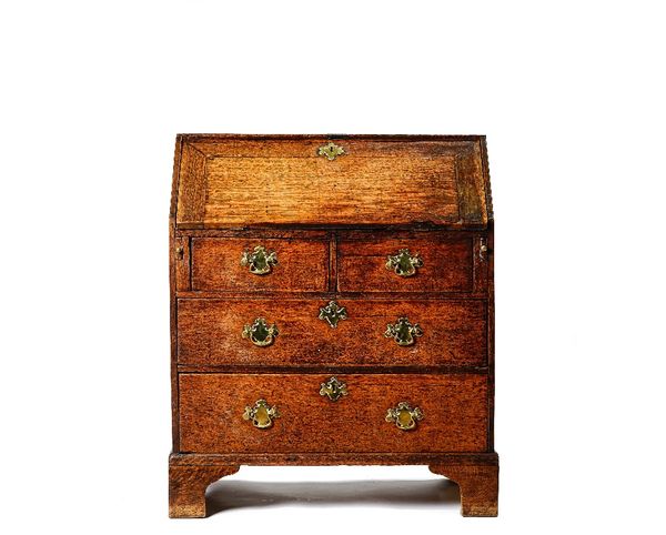 An oak bureau, mid 18th century, the hinged fall enclosing a fitted interior, with two short and two long drawers below, on bracket feet, 76cm wide x