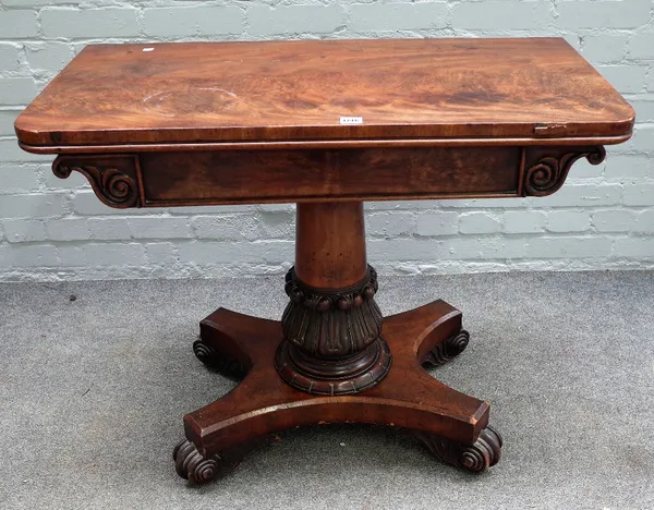 A Regency mahogany foldover card table, on carved and turned column and four scroll feet, 92cm wide x 76cm high.