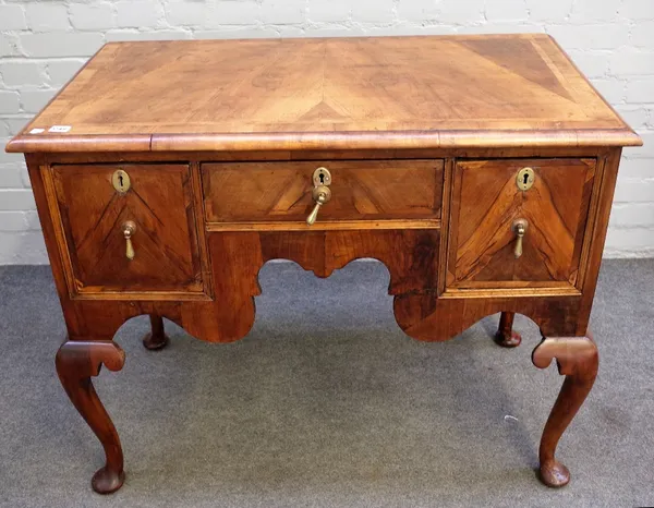 An 18th walnut lowboy, with three drawers about the shaped frieze on pad feet, 101cm x 105cm high.