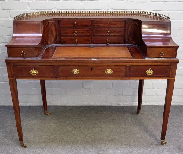 A George III style inlaid mahogany Carlton House desk with three frieze drawers, on tapering square supports, 118cm wide x 98cm high.