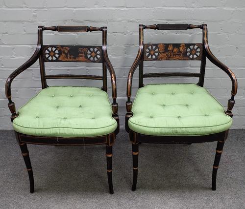 A pair of 19th century parcel gilt ebonised open armchairs, on turned splayed supports, 55cm wide x 84cm high (2).