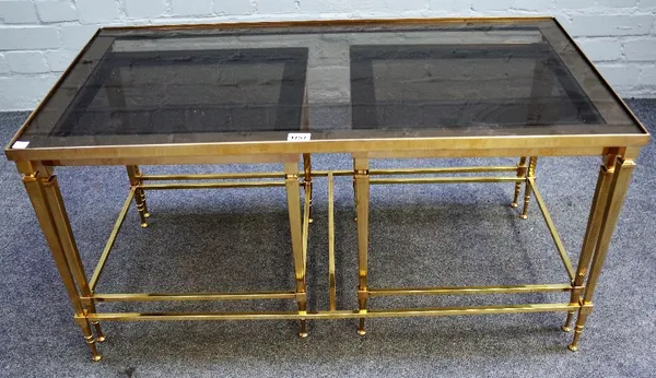 A nest of three 20th century smoked glass and lacquered brass occasional tables, to comprise; a larger rectangular 91cm wide x 46cm high and two small