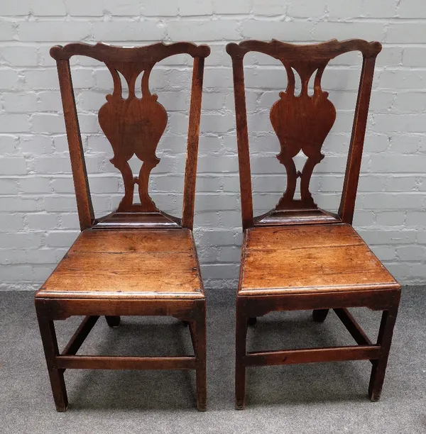 A pair of George III oak country Chippendale style dining chairs, the high backs with shaped pierced and solid splats, solid seats, on rectangular leg