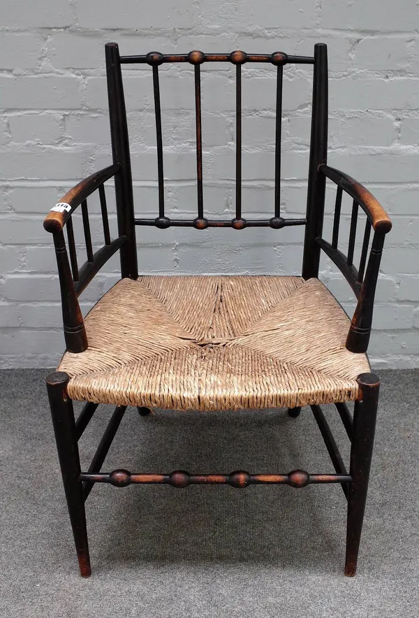 After 'William Morris', a Sussex style ebonised beech open armchair, with turned supports, 53cm wide x 84cm high.