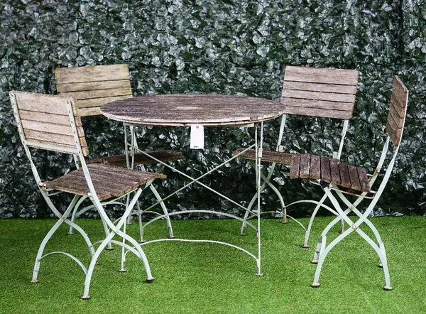 A 20th century wood and metal patio set to comprise; a circular table 90cm wide x 77cm high, together with four matching folding chairs, 46cm wide x 8