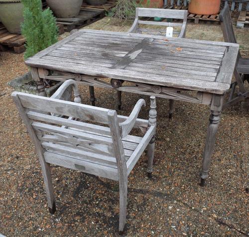 A Sunpoint teak furniture suite, to comprise; a pair of rectangular tables with bullseye mounted frieze on turned supports, 130cm wide x 75cm high, an