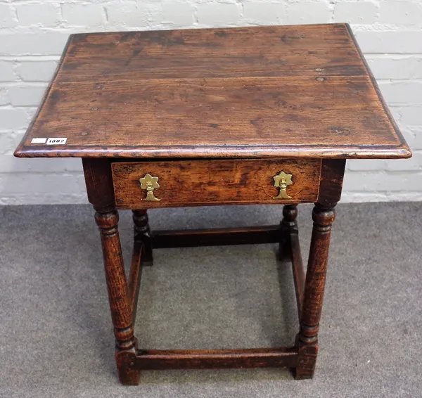 A late 17th century oak side table, the moulded rectangular top above a frieze drawer, on turned and square section legs united by stretchers, 67cm wi