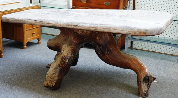 A hardwood rectangular root table, the single slap 8cm thick top on root base with trapped stone, 204cm long.