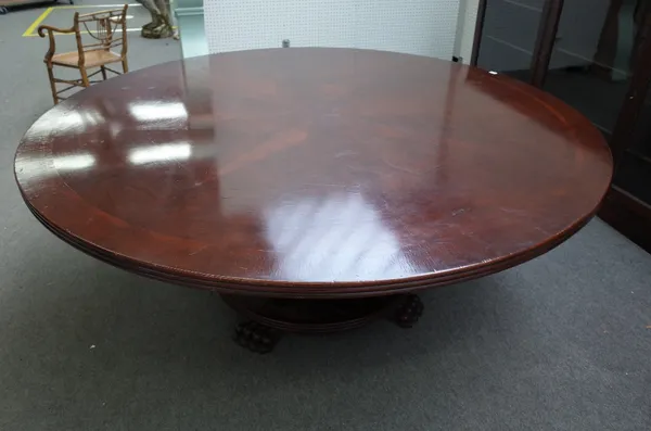 A large Regency style circular mahogany dining table, on turned column and paw feet, 199cm diameter x 80cm high.