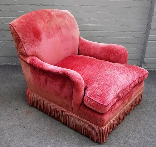 Howard and Sons, a later pink upholstered easy armchair on turned mahogany supports, 80cm wide x 85cm high.
