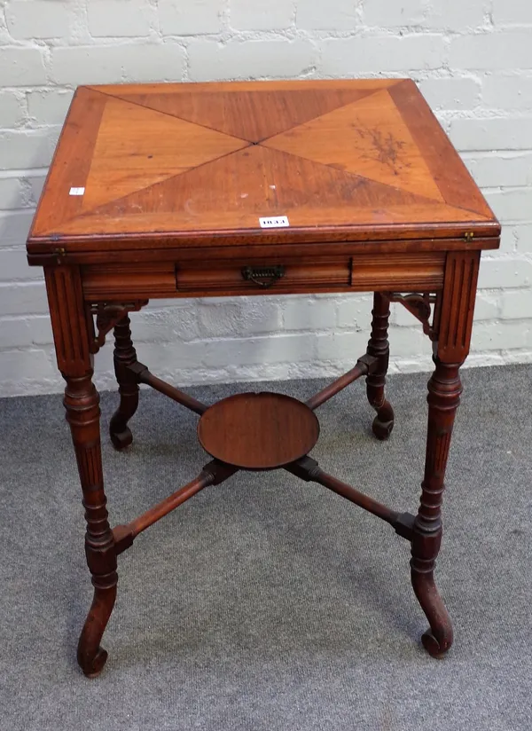 An Edwardian mahogany envelope card table, on four splayed and turned supports, 53cm wide x 74cm high.